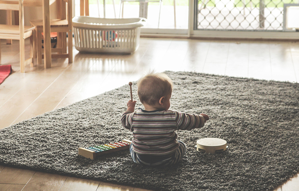 Child playing on carpet